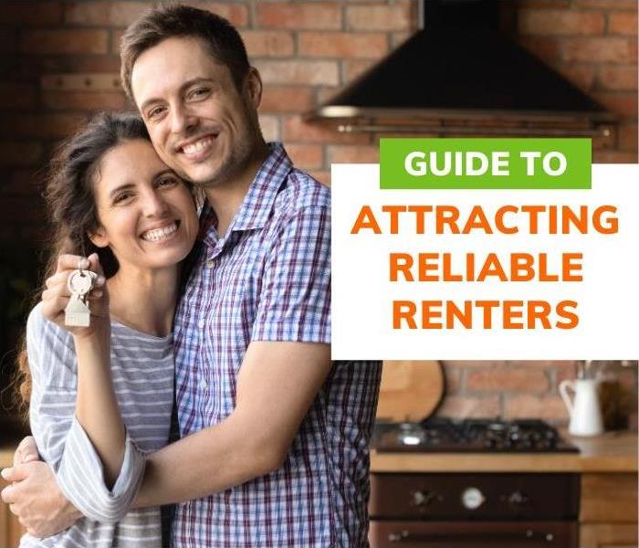 Couple happily holding their keys to their apartment  | Property Managers’ Guide to Attracting Reliable Renters