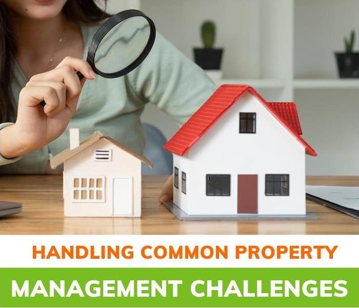 Woman pointing a magnifying glass at two models of houses | Creative Ways to Handle Common Property Management Challenges